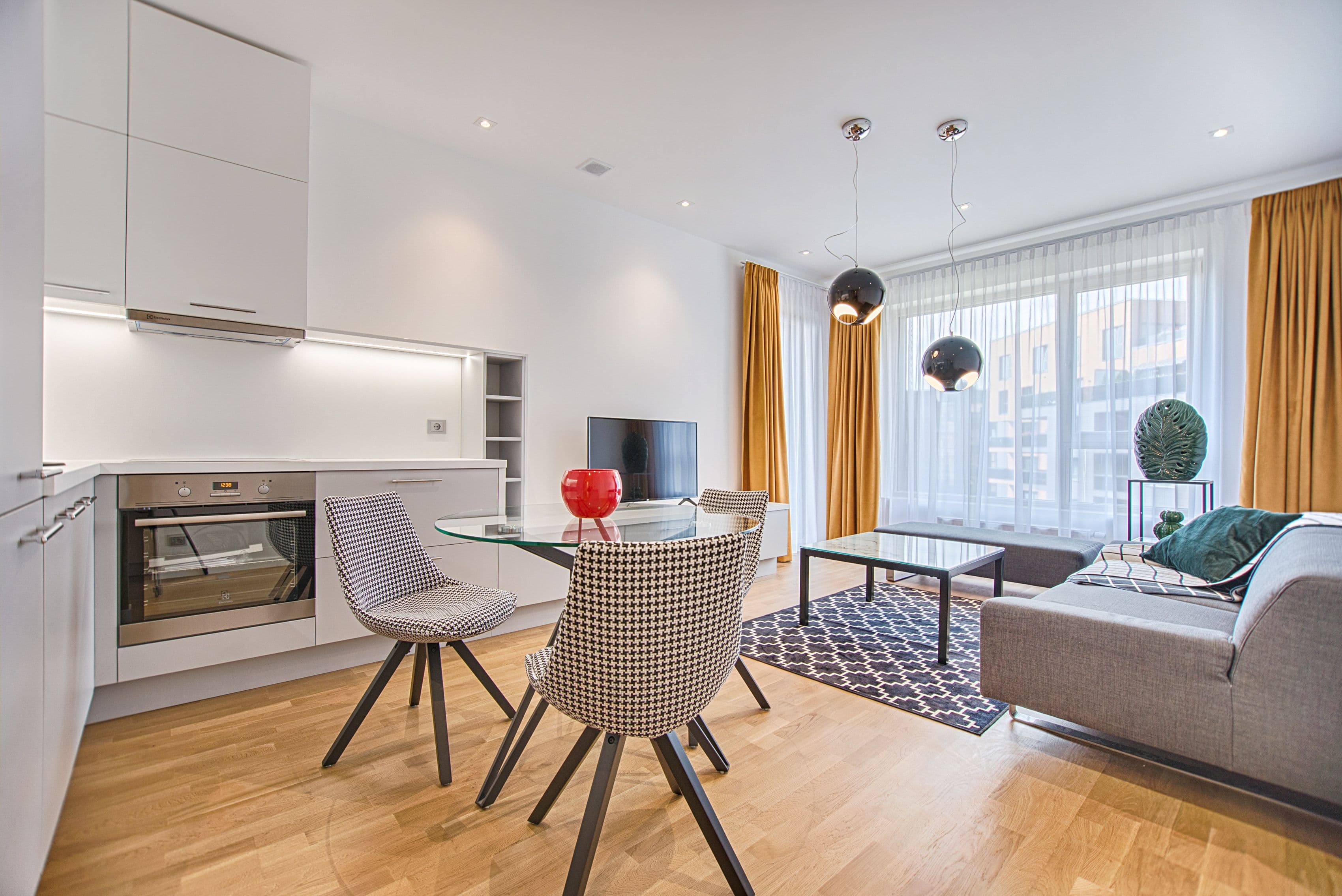 Bright open-plan living room and kitchen in a professionally managed serviced apartment